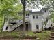 Back of home with a deck, stairs, and large grassy yard at 730 Redlion Run, Alpharetta, GA 30022