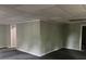 Spacious basement corner with gray walls, white trim, and an open doorway to another room, ideal for customization at 730 Redlion Run, Alpharetta, GA 30022
