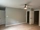 Spacious bedroom with hardwood floors, two doors, and a modern ceiling fan at 730 Redlion Run, Alpharetta, GA 30022