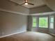 Spacious primary bedroom with tray ceiling, hardwood floors, and large windows offering plenty of natural light at 730 Redlion Run, Alpharetta, GA 30022