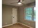 Bedroom featuring hardwood floors, a window with a view, and a ceiling fan with light at 730 Redlion Run, Alpharetta, GA 30022