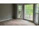 Bedroom with hardwood floors and large windows providing natural light and views of the outdoors at 730 Redlion Run, Alpharetta, GA 30022