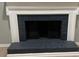 Close-up of the fireplace with a decorative mantle and black tile accents at 730 Redlion Run, Alpharetta, GA 30022