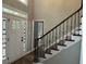 Welcoming foyer with decorative glass front door and staircase with iron spindles leading upstairs at 730 Redlion Run, Alpharetta, GA 30022