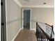 Hallway with freshly painted walls and hardwood flooring providing access to other rooms at 730 Redlion Run, Alpharetta, GA 30022