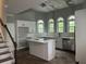 Kitchen featuring a central island, white cabinets, arched windows, and stainless steel appliances at 730 Redlion Run, Alpharetta, GA 30022