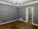 Living room featuring hardwood floors, gray walls, and a modern chandelier at 730 Redlion Run, Alpharetta, GA 30022