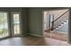 Living room features hardwood floors, three large windows and doorways leading to other rooms at 730 Redlion Run, Alpharetta, GA 30022