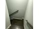 View looking down the carpeted staircase with gray walls and a wooden handrail providing safety and style at 730 Redlion Run, Alpharetta, GA 30022