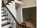 View of the staircase with elegant iron spindles and dark wood treads, leading to the upper level at 730 Redlion Run, Alpharetta, GA 30022