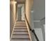 View of the staircase featuring painted stairs and dark wood handrail, leading to a bright upper level at 730 Redlion Run, Alpharetta, GA 30022