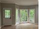 Bright sunroom features three large windows and a door leading to a outdoor deck at 730 Redlion Run, Alpharetta, GA 30022