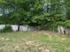 Damaged backyard wooden fence with foliage and mature trees at 1692 Pheasant Dr, Jonesboro, GA 30238