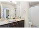 Bathroom featuring double sinks, dark cabinets, and a separate shower area at 2040 Harvest Ridge Cir, Buford, GA 30519