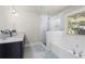 Modern bathroom with stylish tiling, a soaking tub, and glass enclosed shower at 2040 Harvest Ridge Cir, Buford, GA 30519