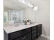 Well-lit bathroom with a double vanity, and a glass enclosed shower with marble tile at 2040 Harvest Ridge Cir, Buford, GA 30519