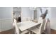 Open-concept dining room and staircase with white table and chairs at 2040 Harvest Ridge Cir, Buford, GA 30519