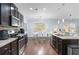 Modern kitchen features stainless steel appliances, granite countertops, and view to dining area at 2040 Harvest Ridge Cir, Buford, GA 30519
