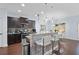 Well-lit kitchen with dark cabinets, granite counters, breakfast bar, and stainless steel appliances at 2040 Harvest Ridge Cir, Buford, GA 30519