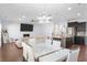 Open-concept living space with modern kitchen, dining area, and comfortable living room with a fireplace at 2040 Harvest Ridge Cir, Buford, GA 30519