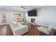 Bright living area with a fireplace, modern furniture, hardwood floors, and a glass coffee table at 2040 Harvest Ridge Cir, Buford, GA 30519