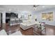 Open-concept living area with a kitchen island, modern furniture, hardwood floors, and plenty of natural light at 2040 Harvest Ridge Cir, Buford, GA 30519