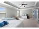 Spacious main bedroom with a trey ceiling, large windows, and comfortable seating at 2040 Harvest Ridge Cir, Buford, GA 30519