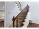Elegant staircase with wood and metal railing and carpeted steps, adding charm to the home's interior at 2040 Harvest Ridge Cir, Buford, GA 30519