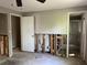 A bedroom displays some exposed framing and doorways to another room and an ensuite at 2317 Wilkins Ct, Decatur, GA 30035