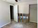 This bedroom needs TLC with an open door and exposed framework in the partial wall at 2317 Wilkins Ct, Decatur, GA 30035