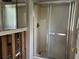 A shower area with sliding doors is shown with exposed framing in the surrounding area at 2317 Wilkins Ct, Decatur, GA 30035