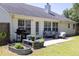 Backyard patio area with ample seating, a grill, and garden, perfect for outdoor enjoyment at 2780 Matlin Way, Buford, GA 30519