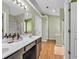 Bright bathroom featuring dual sinks, a shower, and modern fixtures at 2780 Matlin Way, Buford, GA 30519