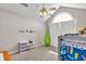 ' bedroom featuring bunk beds, a vaulted ceiling, storage shelves, and a bright, airy atmosphere at 2780 Matlin Way, Buford, GA 30519
