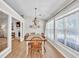 Bright dining room featuring large windows, a modern chandelier, and an adjacent living space at 2780 Matlin Way, Buford, GA 30519