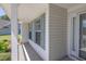 Inviting covered front porch with detailed trim work and natural light streaming through windows at 2780 Matlin Way, Buford, GA 30519