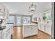 Well-lit kitchen with white cabinets, island, and modern appliances at 2780 Matlin Way, Buford, GA 30519