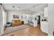 Open-concept living space with a kitchen, hardwood floors, natural light, and a cozy seating area at 2780 Matlin Way, Buford, GA 30519