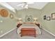 Comfortable main bedroom with a ceiling fan, dual lamps, and decorative wall art at 2780 Matlin Way, Buford, GA 30519