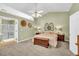 Spacious main bedroom featuring a ceiling fan, a walk-in closet, and an en-suite bathroom at 2780 Matlin Way, Buford, GA 30519