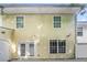 Exterior view of the back of the house with a small patio at 6073 Camden Forrest Dr, Riverdale, GA 30296
