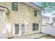Exterior view of the back of the house with a small patio at 6073 Camden Forrest Dr, Riverdale, GA 30296
