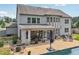 Aerial view of backyard with a pool, patio, outdoor seating, and lush landscaping, surrounded by trees and fencing at 776 Amos Ln, Kennesaw, GA 30152