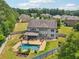 Aerial view of a private backyard featuring a swimming pool, covered patio, and beautifully landscaped surroundings at 776 Amos Ln, Kennesaw, GA 30152