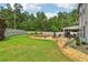 Spacious backyard with swimming pool, covered patio, outdoor seating, beautiful landscaping and fenced perimeter at 776 Amos Ln, Kennesaw, GA 30152