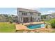 Spacious backyard with a sparkling swimming pool, covered patio, outdoor seating, and beautifully landscaped areas at 776 Amos Ln, Kennesaw, GA 30152