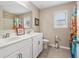 Bright bathroom features double sink vanity, framed mirror, tile floor, and neutral color palette at 776 Amos Ln, Kennesaw, GA 30152