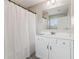 Bathroom featuring tub and shower, white vanity, large mirror, and neutral color palette at 776 Amos Ln, Kennesaw, GA 30152