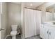 Bathroom featuring toilet, tub, white vanity, framed mirror, and neutral color palette at 776 Amos Ln, Kennesaw, GA 30152
