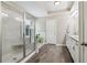 The bright bathroom offers a glass shower, soaking tub, double vanity, and tiled floor at 776 Amos Ln, Kennesaw, GA 30152